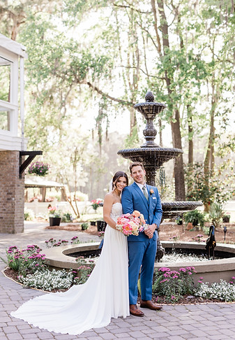 bride and groom in front of fountain at The Mackey House in Savannah