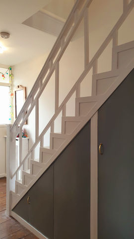 Refurbished staircase with balustrades crafted by cutting and reworking the original wood, creating a streamlined and contemporary look.