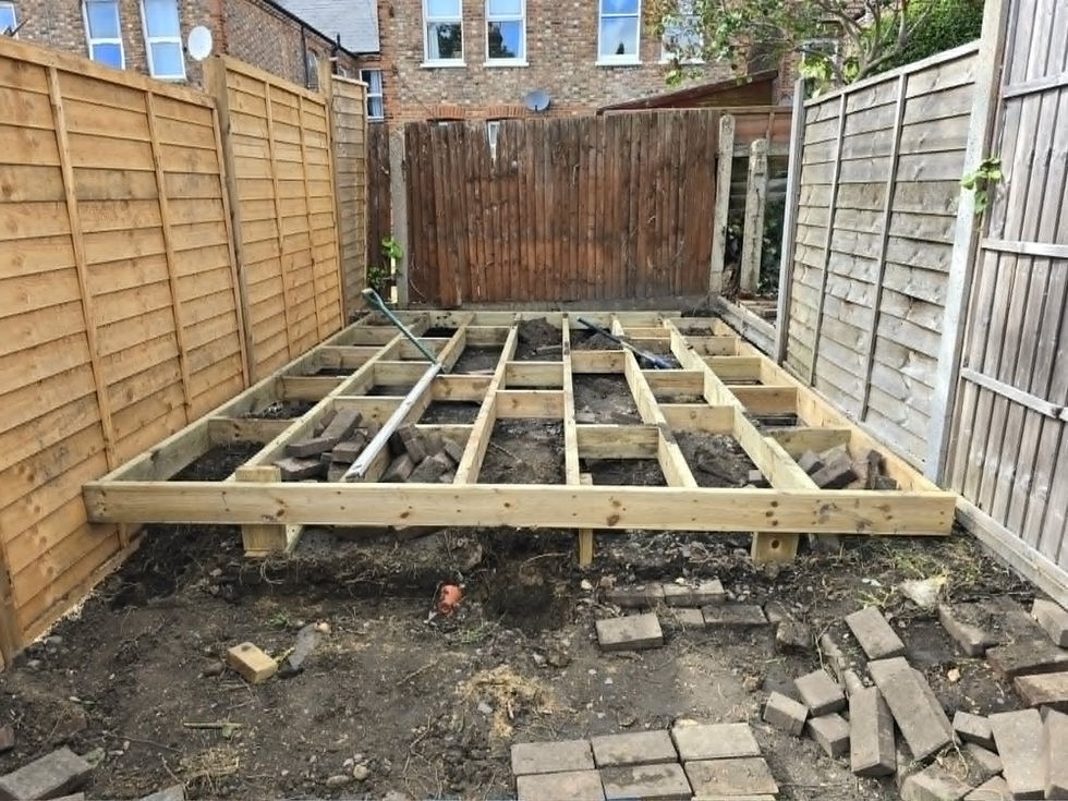 Decking subframe and joists being installed during a full garden renovation in Walthamstow, E17 - timber decking construction