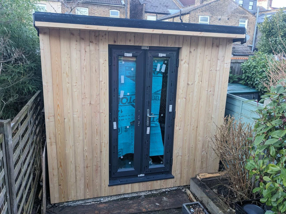 Outdoor office structure in Leyton at an early installation stage with new timber cladding and doors.