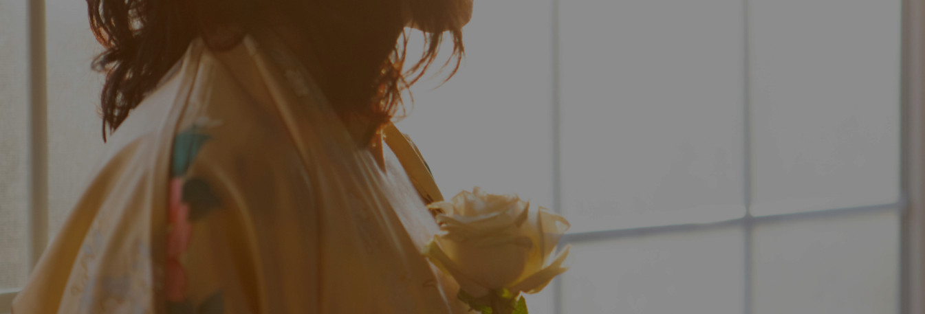 Woman with a rose in the sunlight_edited