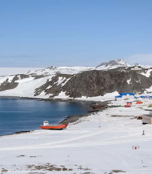 King George Island Antarctica with snowy landscape and research station, South Shetland Islands expedition cruise destination, luxury polar travel experience.