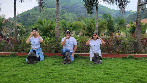 1GEN team member posing with a statue, smiling for a photo during a team outing.