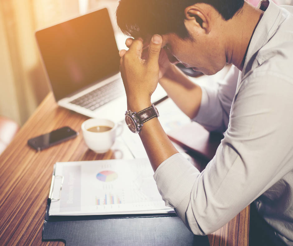 Young professional holding his head being stressed