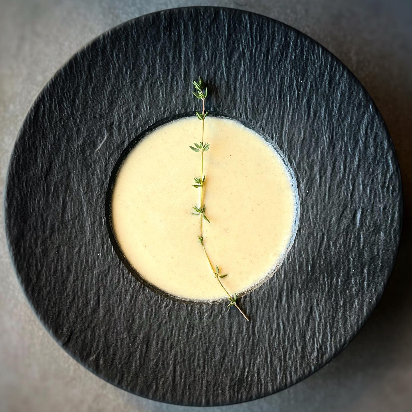 Creamy vegan roasted cauliflower soup with herbs and black pepper