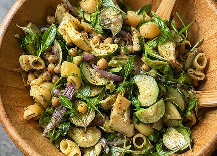 Roasted zucchini pasta salad with artichokes, chickpeas, arugula, dill, capers, and lemon Parmesan dressing