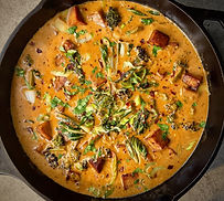 Golden tofu cubes in creamy coconut lime sauce with cilantro, green onions, and lime
