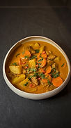 Creamy vegan Massaman curry with potatoes, carrots, and tofu over rice