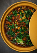 Butternut squash and chickpea tagine with dates, olives, herbs, and couscous