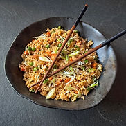 Vegetable fried rice with carrots, peas, red onion, green onions, and sesame seeds