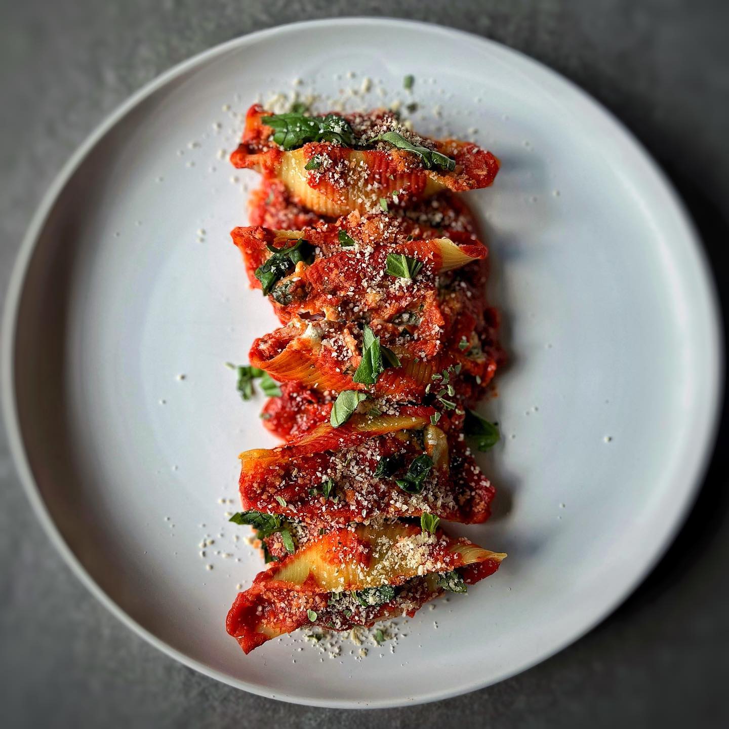Vegan spinach and ricotta stuffed pasta shells baked in marinara sauce