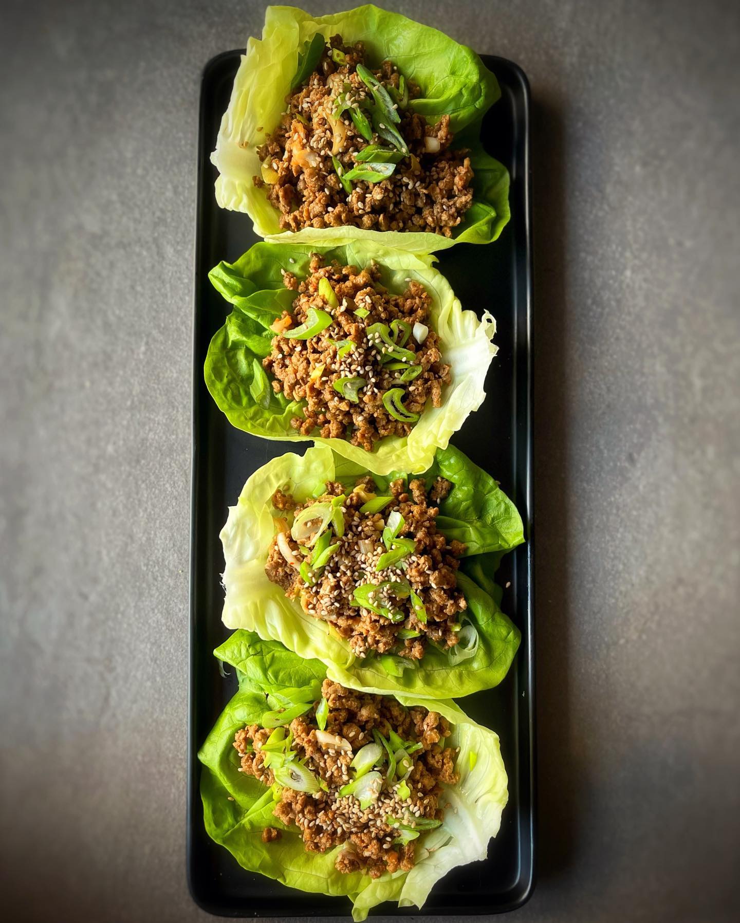 Asian vegan lettuce wraps with savory TVP filling and spicy peanut sauce