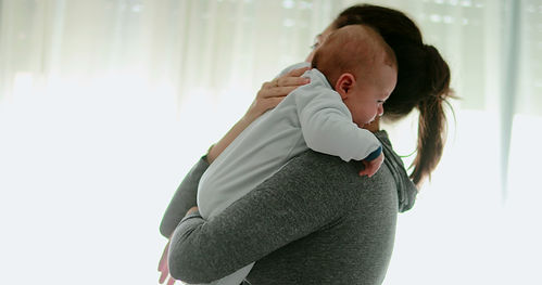 Authentic mother consoling crying baby newborn boy.jpg