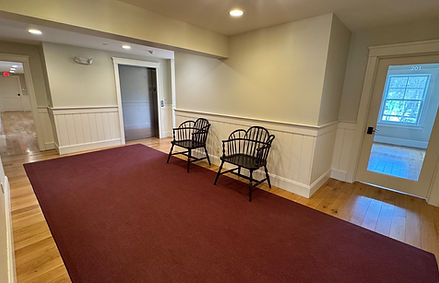 Waiting area depicting an elevator and 2 chairs.