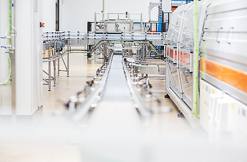 Image of conveyor belt and automated system in a facilty.