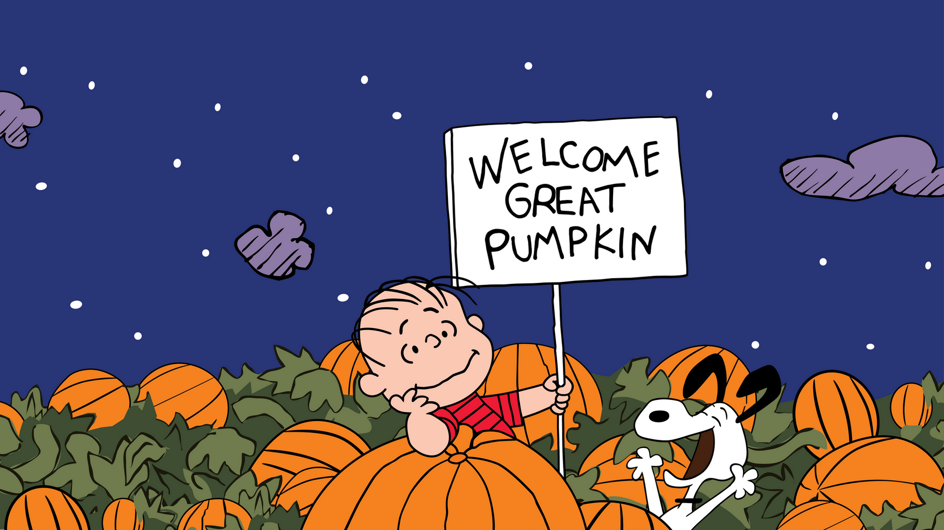 A boy and a dog standing in a pumpkin patch with a sign that says welcome great pumpkin