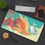 Thumbnail: Sleepy Orange Dragon Desk Mat – Whimsical Fantasy Cloud Design