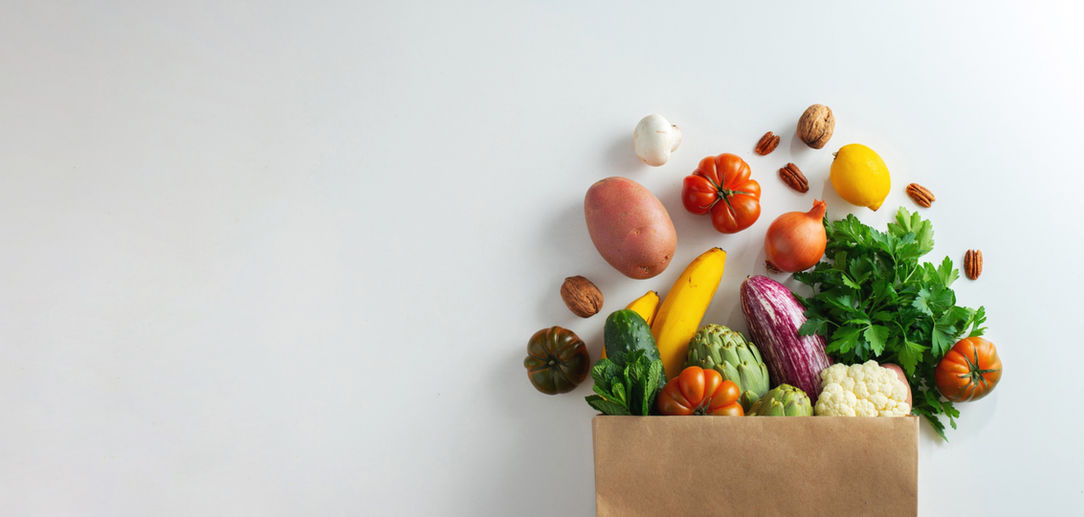 Delivery healthy food background. Healthy vegan vegetarian food in paper bag vegetables an