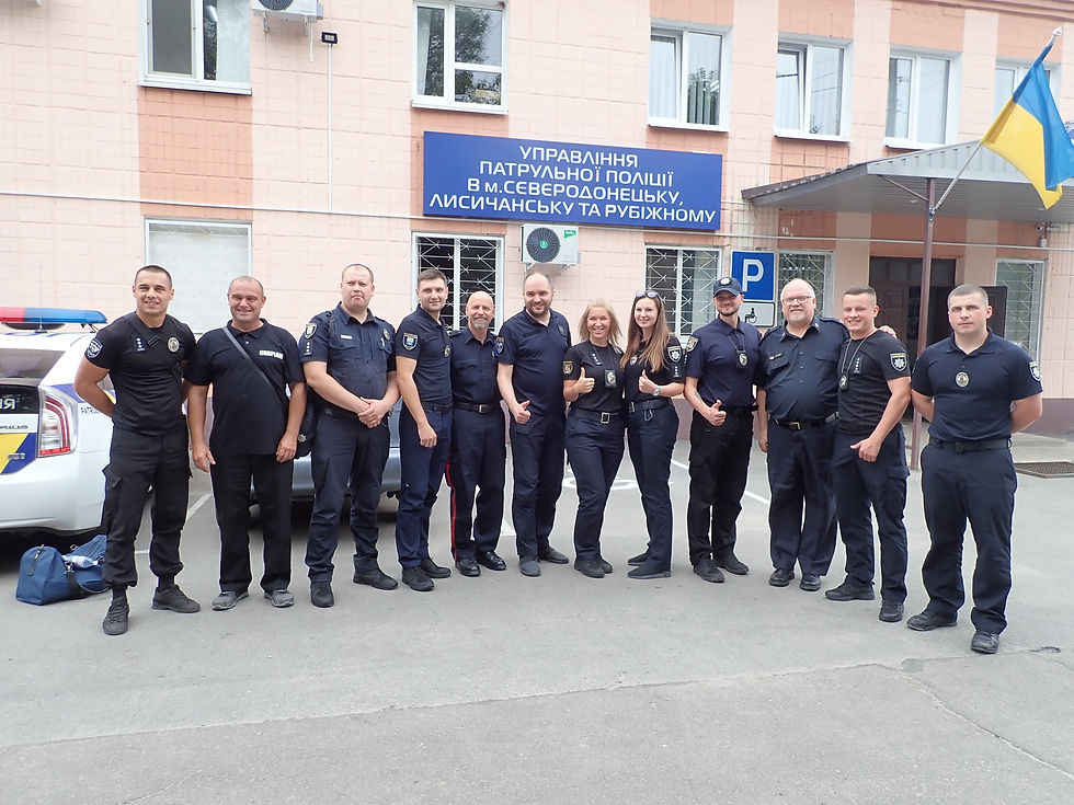 Hillar with his arm around the Acting Police Chief for the Luhansk Region of the Patrol Police