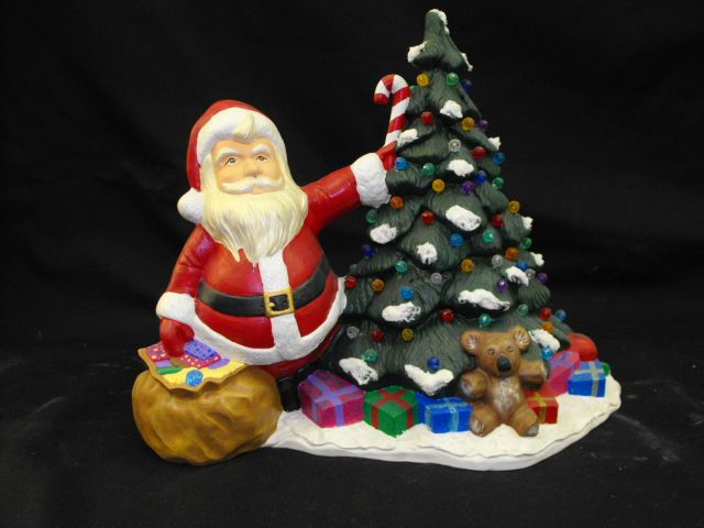 santa standing with tree