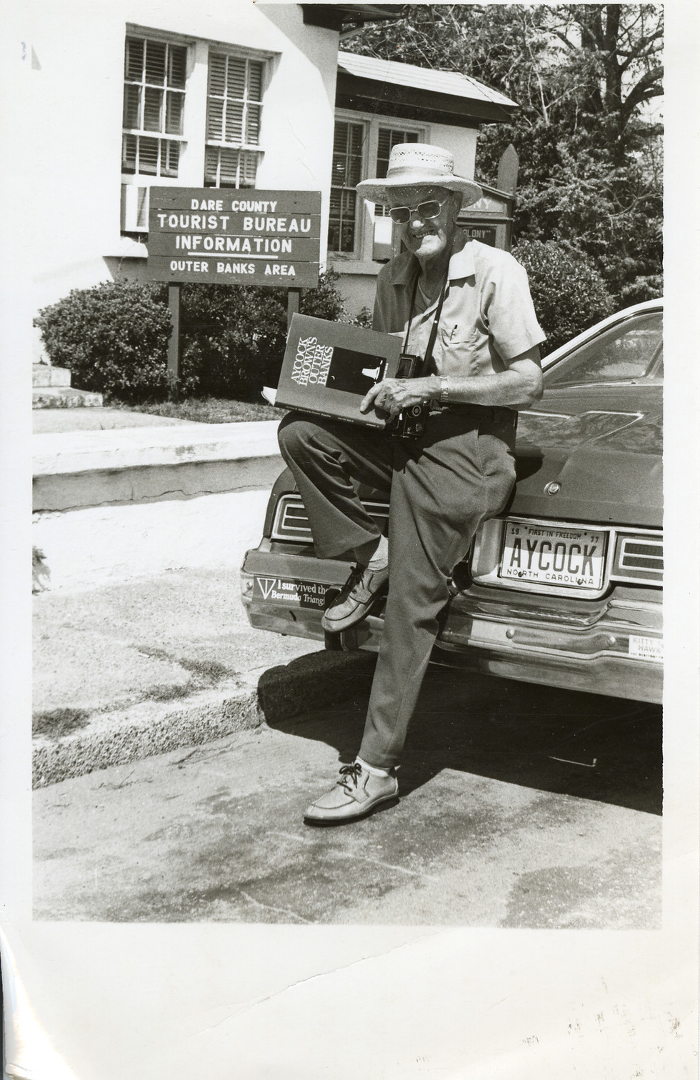ORG_5271_prnt_Aycock_with_Book_In_Front_Of_Dare_County_Tourist_bureau_nd_OBHC.jpg