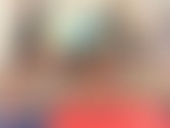 Five children in colorful shirts lean over a red bar in a classroom, playful mood, with toys and a rope on the floor nearby.