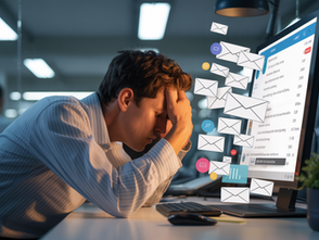 Stressed man in an office holds head, overwhelmed by emails on computer screen. Bright screens and flying envelope icons convey urgency.