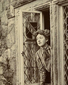 Agatha Christie as a young woman looking out a window in the 1910s.