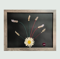 A captivating pressed floral arrangement of daisies and lavender is set against a dark backdrop, creating a striking visual contrast. The rich tones of the flowers, accented with touches of red, white, and green, elegantly capture the spirit of the holidays. This piece embodies nature's enduring elegance with a festive twist.
