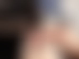 A stylist applying custom hair extensions to a client in a salon setting