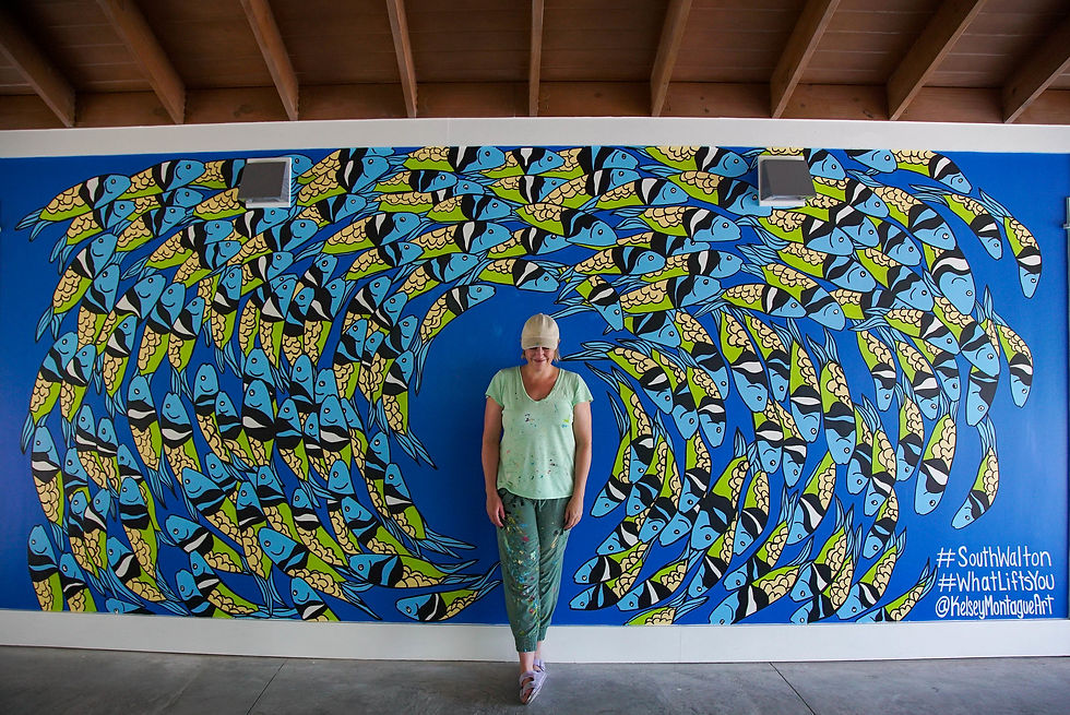 Artist Kelsey Montague poses with her completed mural at the Grayton Beach Central Parking Facility