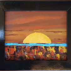 Sun setting over land and water, browns, blues and yellow, in a black frame