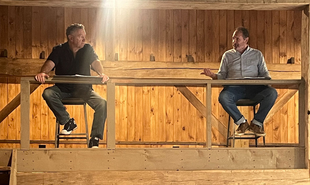 Actors reading in a barn
