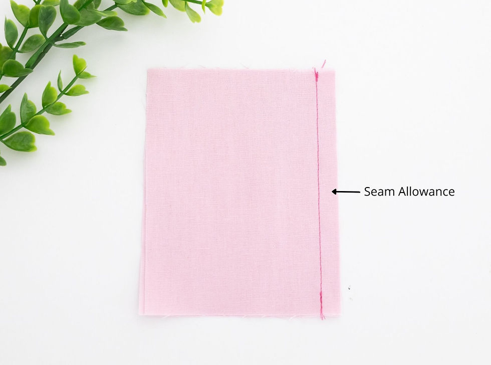 Pink fabric with a seam to highlight the seam allowance.