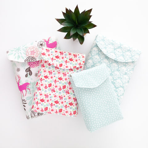 A set of four fabric book sleeves in pasel colours. 