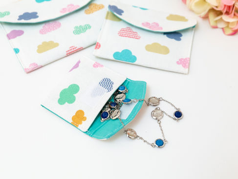 A set of three flat, envelope style pouches sitting on a table.