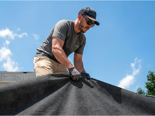 contractor holding membrane geotextile.png