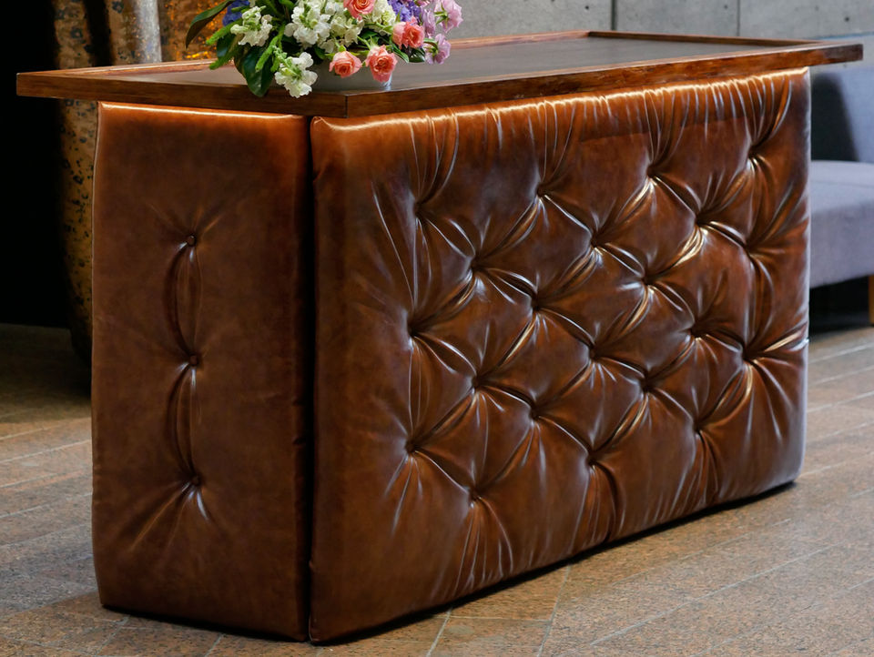 A stylish whisky bar with tufted leather sides