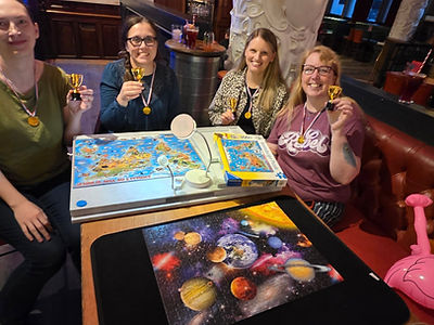 Winning team with medals at a Jigsaw Mania puzzle night in Newcastle