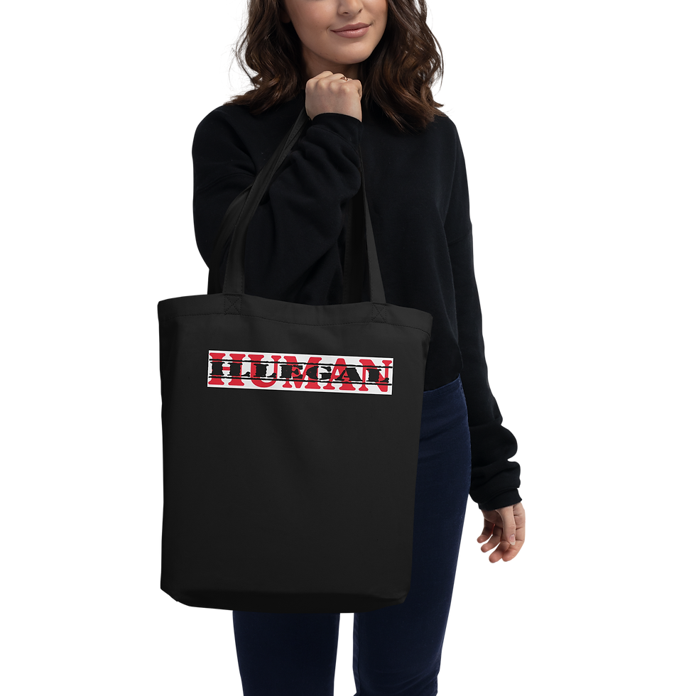 Woman holding black tote bag with HUMAN in red and white