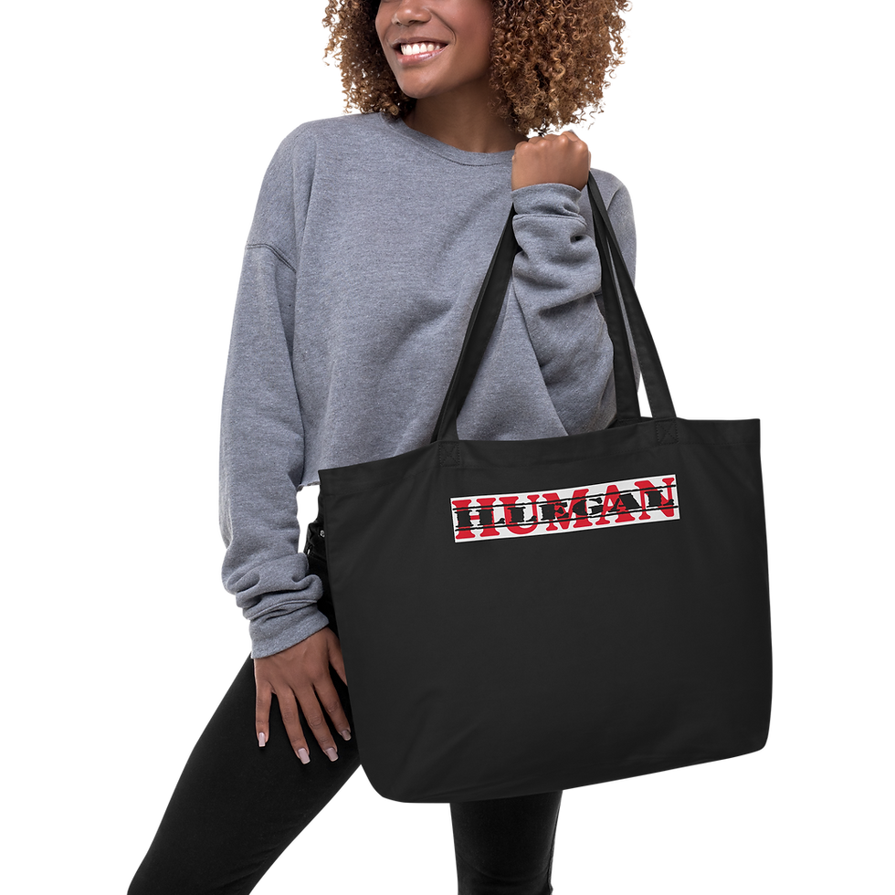 Woman holding black tote bag with HUMAN text