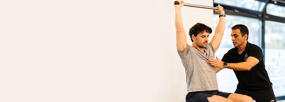 Shay Harel coaching a private Pilates session