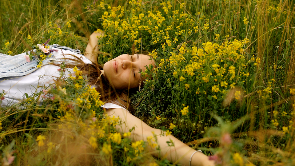 Woman laying in a field of flowers