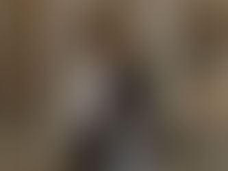 two men talking, one is holding a bicycle