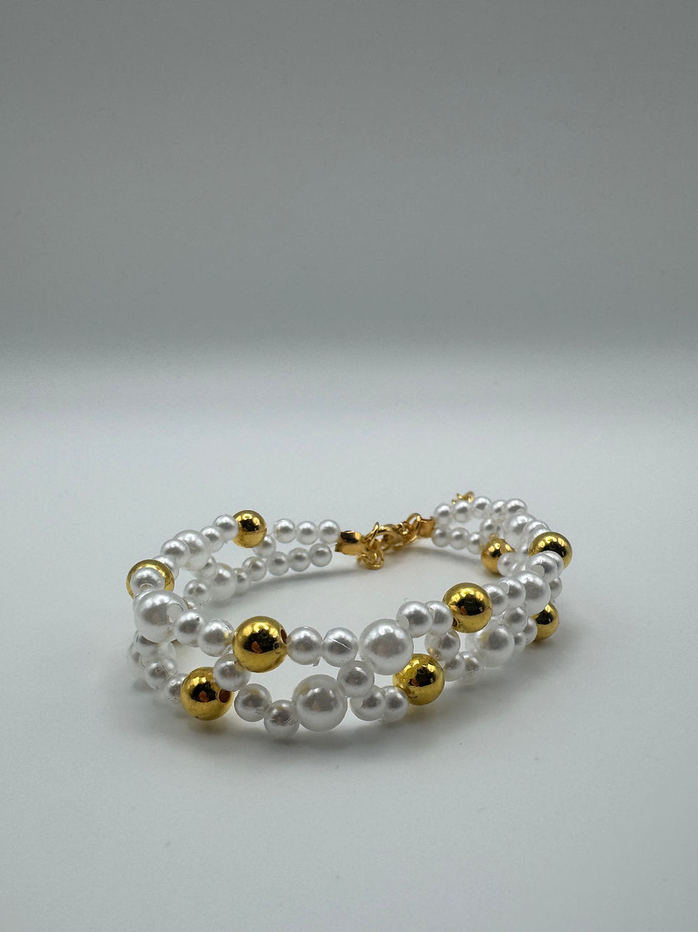 Thumbnail: Elegant Double-Strand Pearl Bracelet with Gold Bead Accents