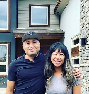 Smiling clients in front of their new home in the Columbia Valley