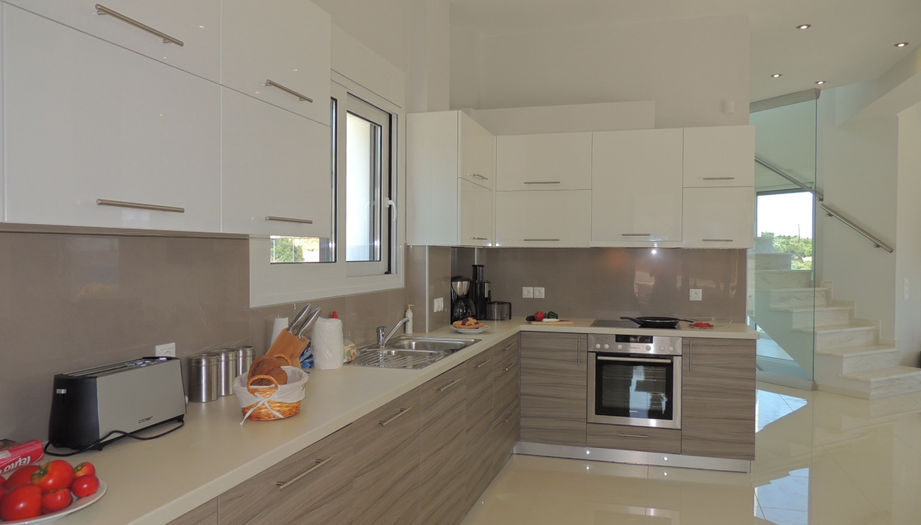 23 Zeus Bay modern kitchen and marble staircase.JPG