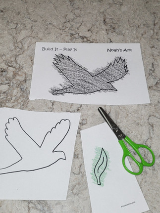 Cutting out the shapes of a dove and raven.Big Box Noah's Ark project. Bible activities for kids_