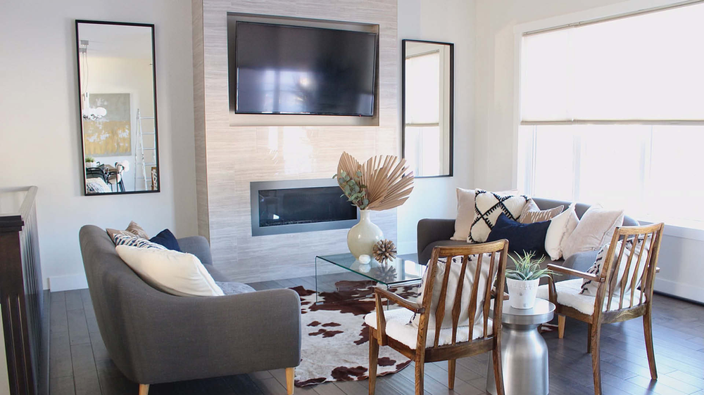 Staged Living Room | Floor to Ceiling Fireplace with Two Couches and Two Chairs Surrounding