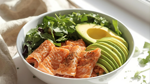 Fresh Keto Mediterranean breakfast bowl with salmon, avocado, and greens